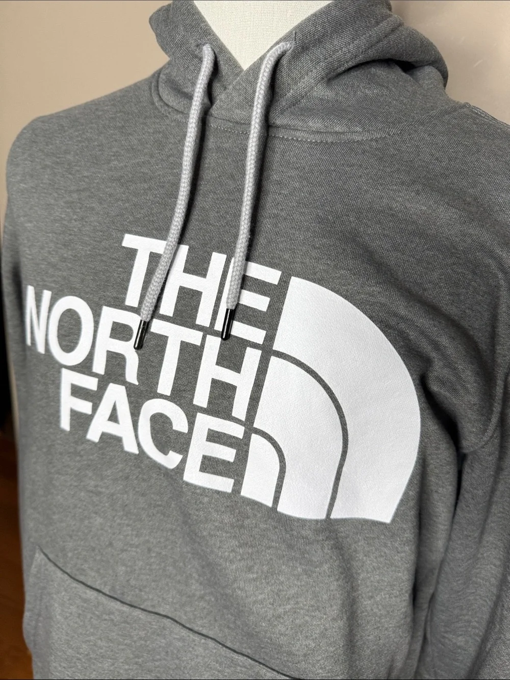 The North Face mens gray hooded sweatshirt size M with pockets.